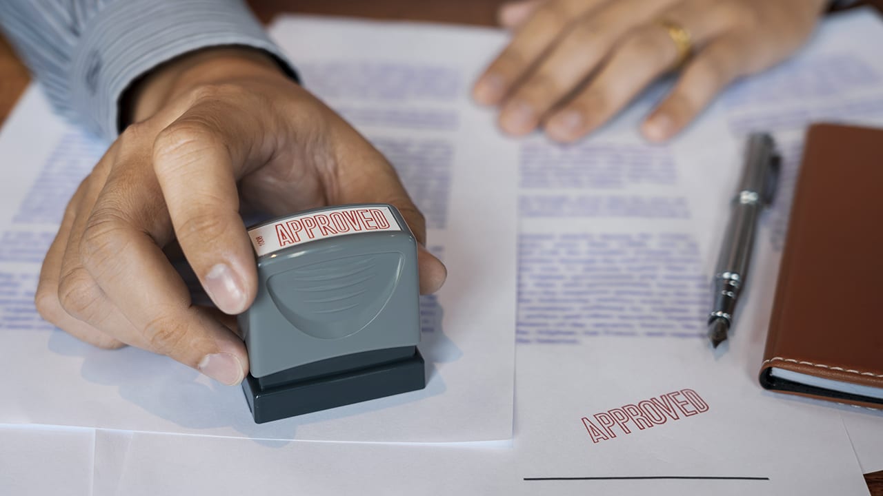 businessman Hand notary public hand ink appoval stamper Stamping